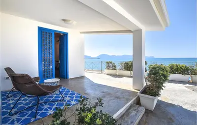 a porch with a chair and a view of the ocean at Nice Home In Balestrate in Balestrate