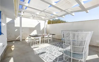 a patio with a table and chairs on it at Nice Home In Balestrate in Balestrate