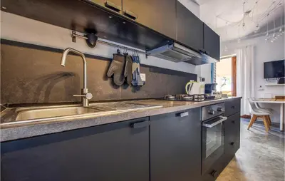 a kitchen with a sink and a stainless steel counter at Nice Home In Balestrate in Balestrate