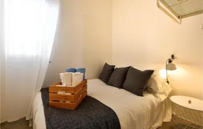 a bedroom with a bed with a night stand on it at Nice Home In Balestrate in Balestrate