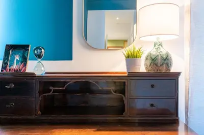 a dresser with a mirror and a lamp on it at Libertà #102 - Guest House Palermo in Palermo