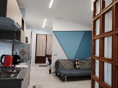 a small living room with a couch and a kitchen at Loft 2 in Mondello beach Mt. 200 from sea. in Palermo