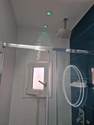 a bathroom with a shower with a window and a shower curtain at LA CASA DI TIAGO in Palermo