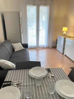 a living room with a couch and a table at Le Palme House Isola delle Femmine in Isola delle Femmine