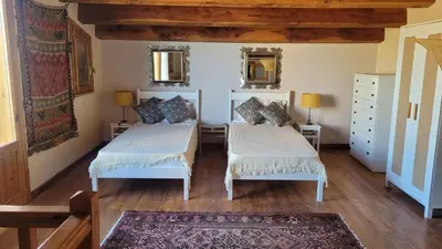 a bedroom with two beds and two mirrors at Villa Jesabel in Scopello
