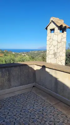 a wall with a small tower on top of it at Villa Jesabel in Scopello