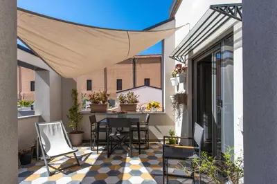 a patio with chairs and a table on a balcony at Pomodoro House allo Spasimo by Wonderful Italy in Palermo