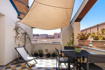 a kitchen and living room with a checkered floor at Pomodoro House allo Spasimo by Wonderful Italy in Palermo