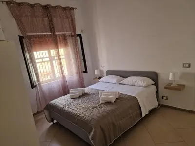 a bedroom with a bed with two towels on it at Casa Poseidonia - intero alloggio in riva al mare in Carini