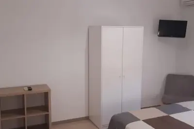a bedroom with a bed and a tv on a wall at Casa Poseidonia - intero alloggio in riva al mare in Carini
