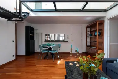 a living room with a table and a couch at Vicolo Paternò Apartments in Palermo