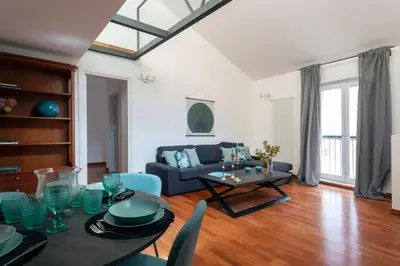 a living room with a blue couch and a table at Vicolo Paternò Apartments in Palermo