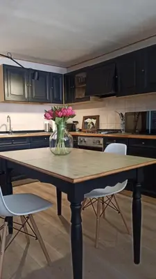a kitchen with a table with a vase of flowers on it at Pia's Home in pieno centro storico in Palermo