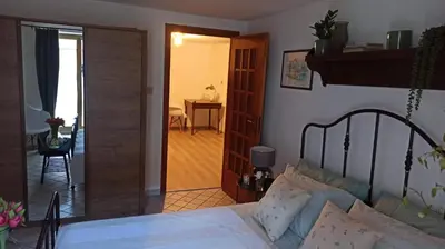 a bedroom with a bed and a door leading into a room at Pia's Home in pieno centro storico in Palermo