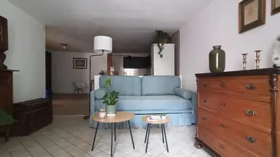 a living room with a blue couch and a table at Pia's Home in pieno centro storico in Palermo