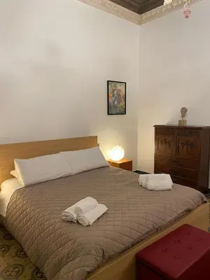 a bedroom with a bed with two towels on it at Amari 106 in Palermo