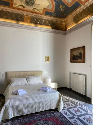 a bedroom with a bed with a coffered ceiling at Amari 106 in Palermo