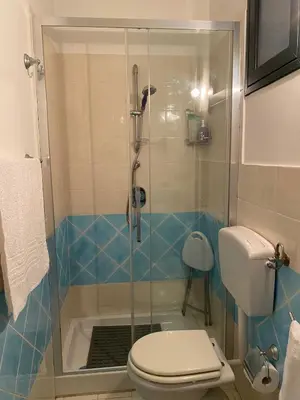 a bathroom with a glass shower with a toilet at Amari 106 in Palermo