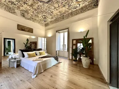 a bedroom with a bed and a coffered ceiling at Casa Guilla_alla Cattedrale in Palermo