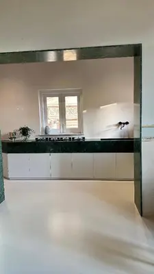 a white kitchen with a counter and a window at Casa Guilla_alla Cattedrale in Palermo