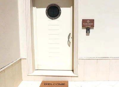 a door with a welcome sign in front of it at Elimi Home Appartamenti in Nuova Gibellina