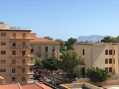 a view of a city with buildings and cars at Large flat near Botanical Garden & Central Station in Palermo