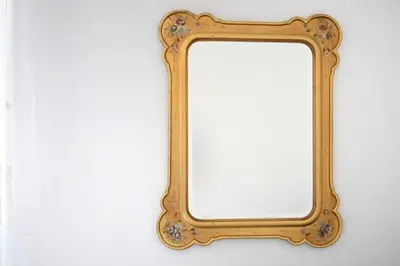 a mirror with a gold frame on a wall at iFlat Dimora del Cassaro in Palermo