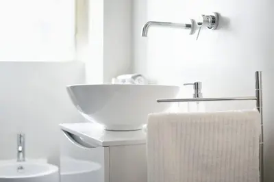 a white bathroom with a sink and a towel at iFlat Dimora del Cassaro in Palermo