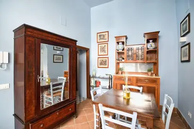 a dining room with a wooden table and chairs at iFlat agli Archetti del centro in Palermo