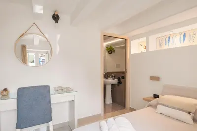 a bedroom with a bed and a mirror and a sink at Iverlid Home. in Palermo